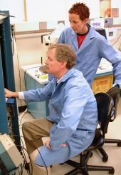 Instrument scientists at lab test console